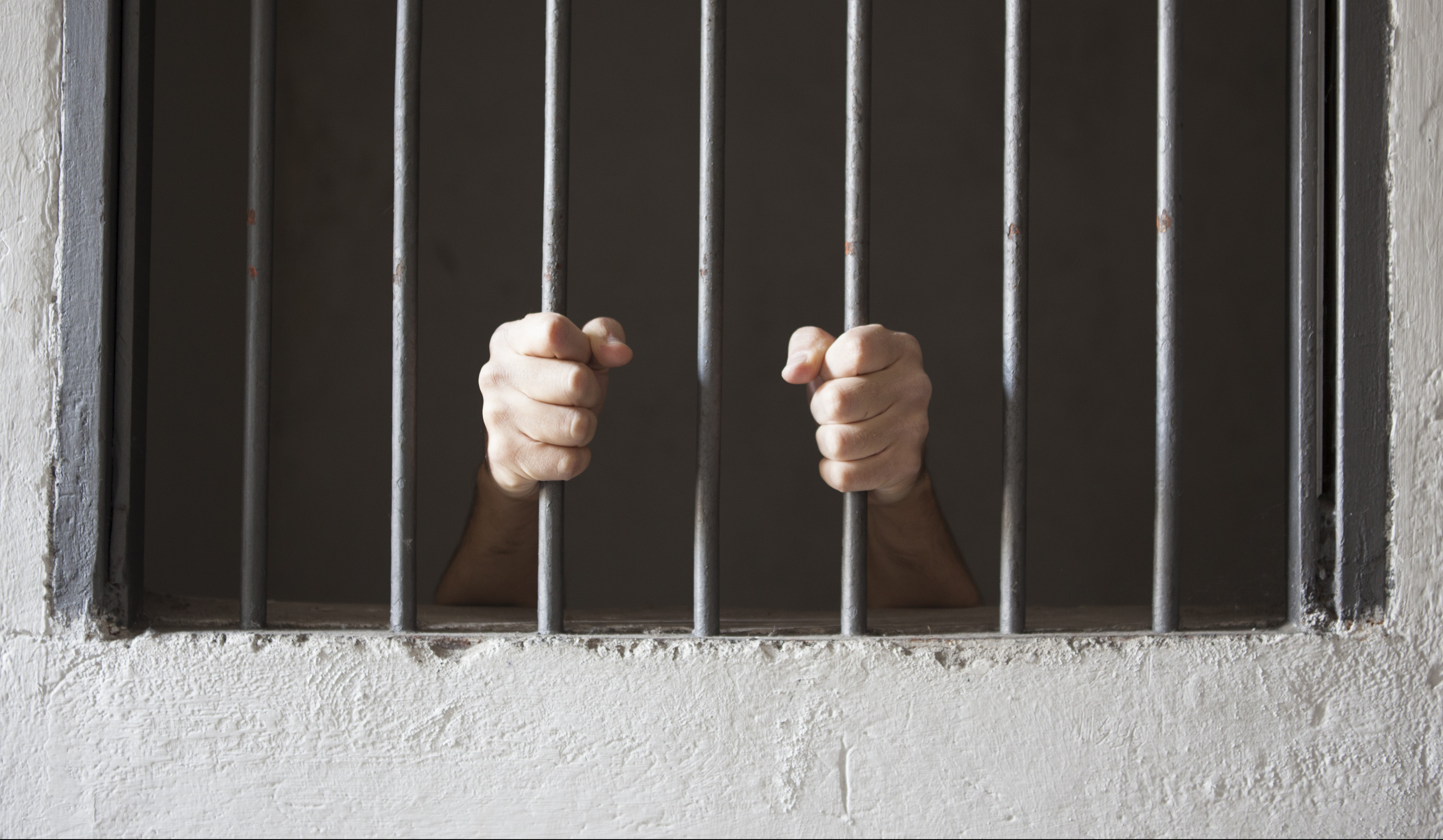 Hands On Prison Bars